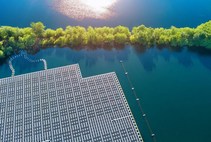 Aerial view of Floating solar panels cell platform system park farm on the lake